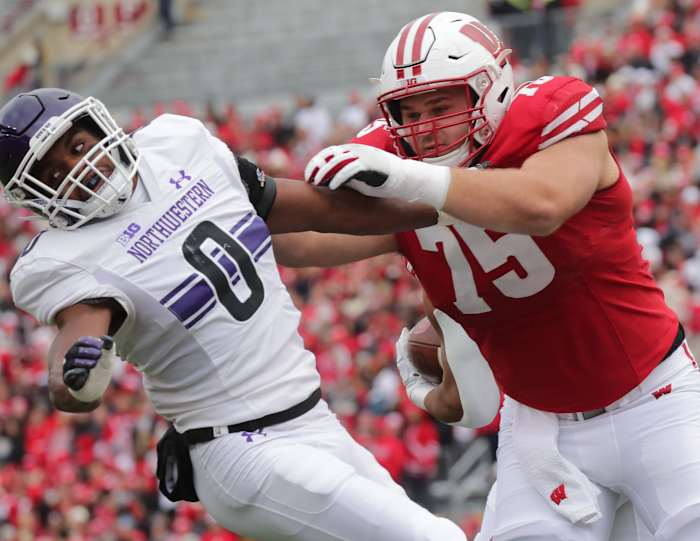 Wisconsin center Joe Tippmann pancakes a Northwestern player